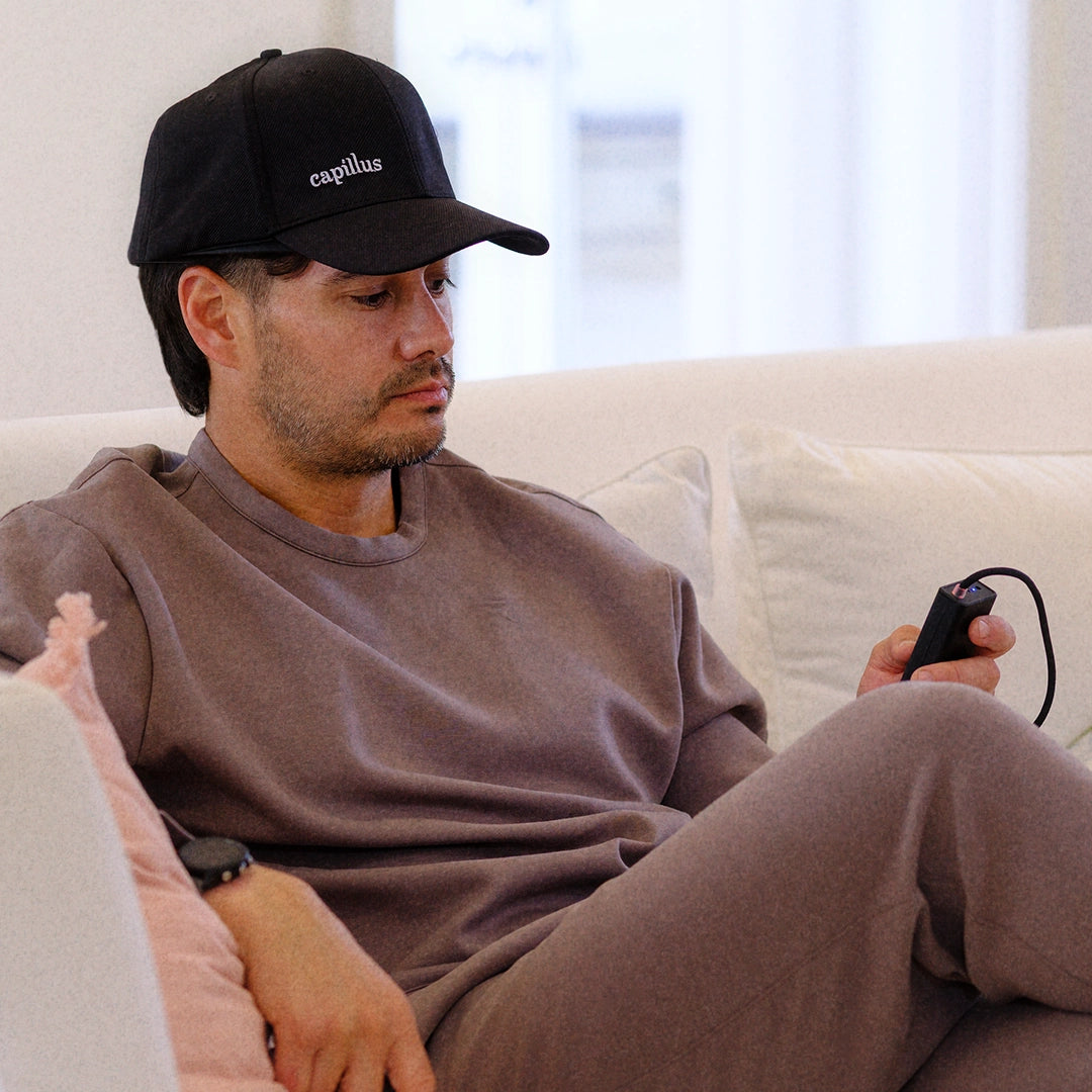 Patient wearing a Capillus laser cap