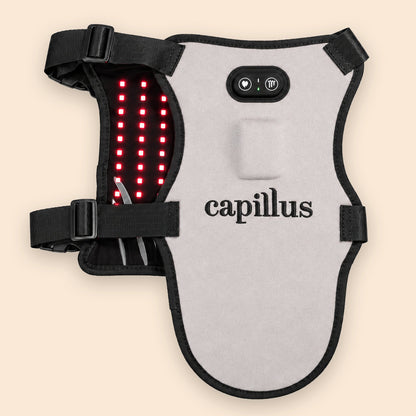 The Capillus Pet Vest by Capillus is a wearable device featuring adjustable straps and visible red LED lights inside, designed for therapeutic use to provide red light therapy for dogs and support their joint comfort.