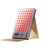 The Capillus Red Light Therapy Panel features multiple red LEDs, a digital display, and sits in a beige stand—perfect for at-home light therapy sessions.