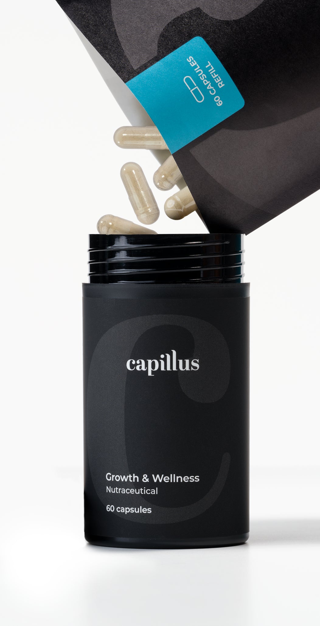 A black container labeled capillus Growth & Wellness Nutraceutical, 60 capsules is open, with several beige capsules being poured from a packet above into the container.